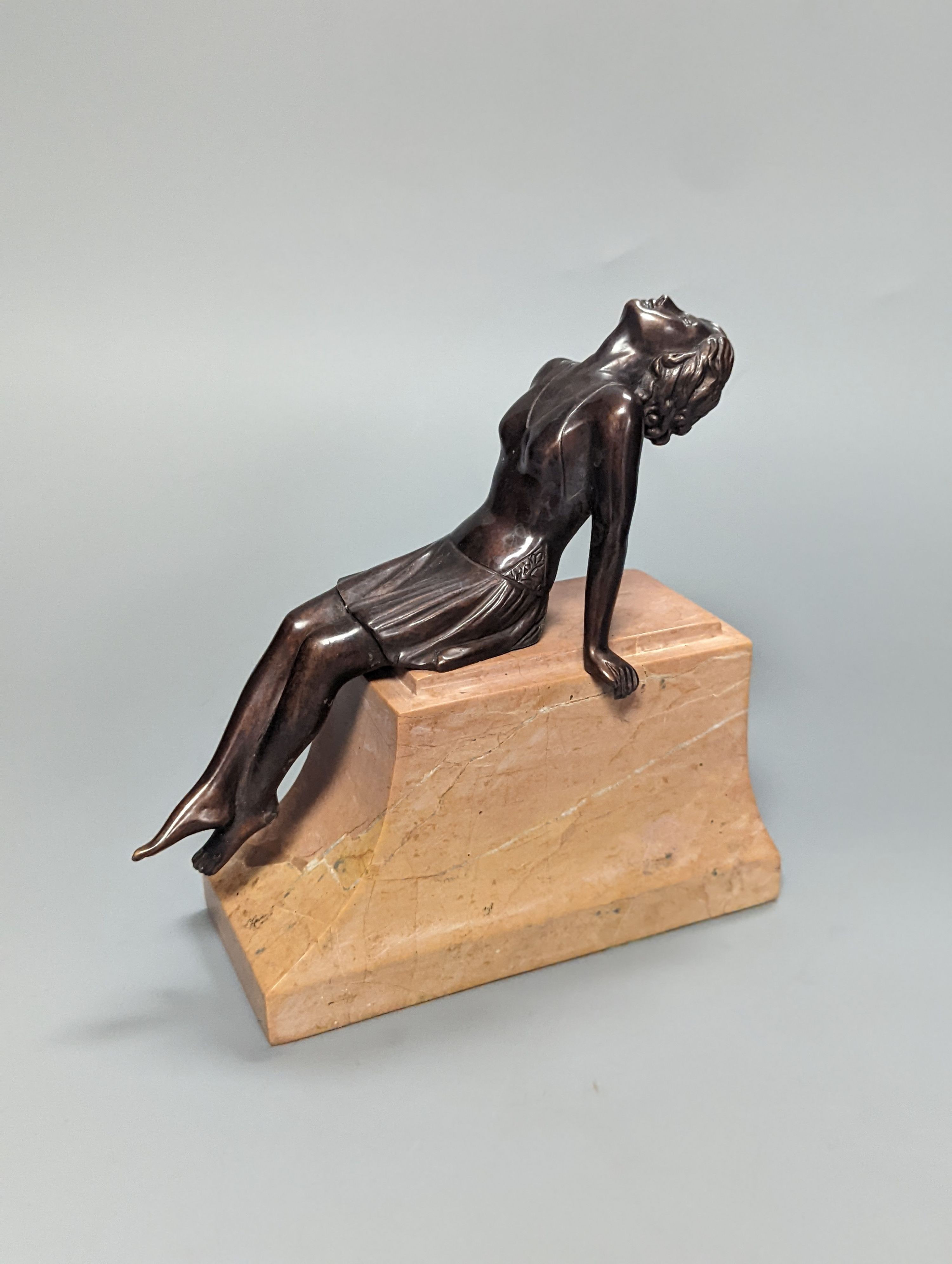 A French Art Deco style bronze of a reclining lady, on marble plinth 18cm